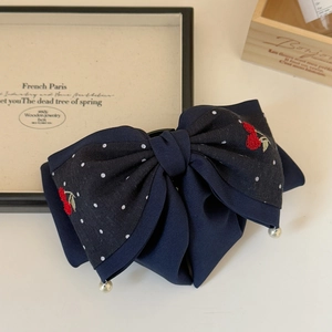 Navy blue bow hair claw with cherry embroidery, white polka dots, and pearl charms