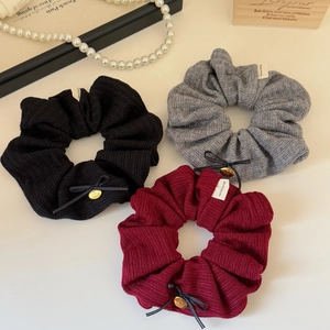 Three-piece vintage knit scrunchie set in black, grey, and red with golden cherry charms
