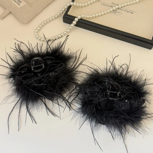 Vue détaillée de pinces à cheveux en plumes noires avec paillettes, ensemble de deux pièces