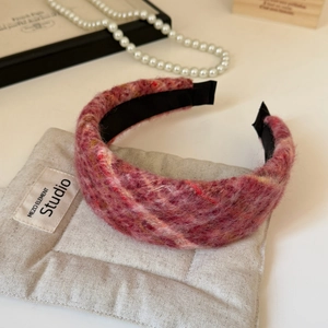 Detail of red tweed headband with textured multi-color weave and non-slip lining