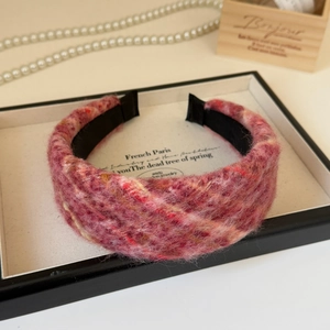 Luxe plush twisted headband in pink and purple fuzzy fabric with cross-knot design