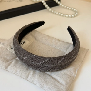 Détail du serre-tête large en tissu à rayures blanches avec doublure en velours noir