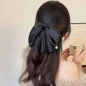 Polka dot bow hair claw clip with pearls for elegant half-up hairstyles on women