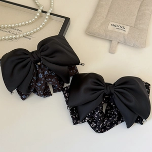 Elegant double-layered black satin bow hair clip with floral patterns and bead accents