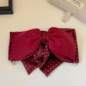 Detail of vintage burgundy bow hair claw with white polka dots and pearl pendants
