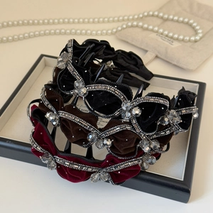 Close-up of velvet padded headbands with sparkling rhinestones and crystals in three colors