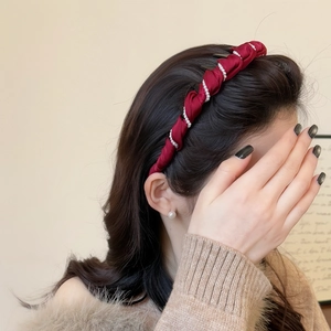 Elegant red velvet headband with pearls on long wavy hair for a stylish look