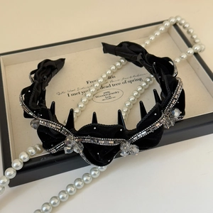Close-up of black velvet headband with sparkling rhinestones and crystal beads