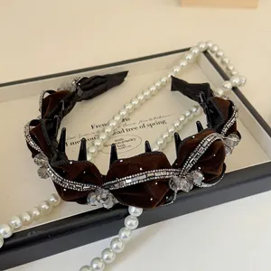 Close-up of brown velvet headband with silver rhinestones and crystal beads
