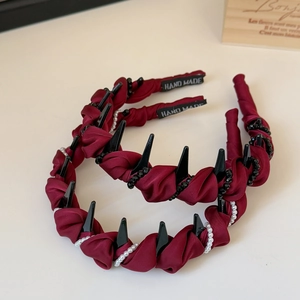 Set of two burgundy fabric headbands with black comb teeth and elegant pearl accents