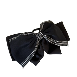 Elegant black fabric bow hair claw clip with houndstooth patterned edges for women