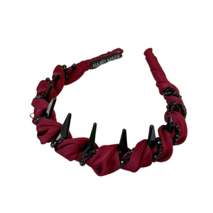 Handmade burgundy satin headband with black spikes and beads on a clean white background