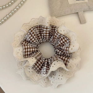 Detail of vintage French lace scrunchie with brown plaid fabric and embroidery