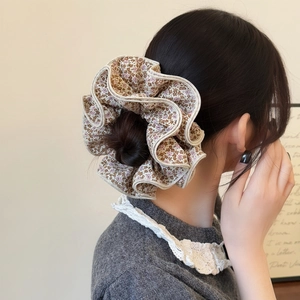 Floral oversized scrunchie hair tie with scalloped edges for low bun hairstyles