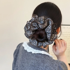Floral oversized hair scrunchie with blue pattern and lock-edge design on model