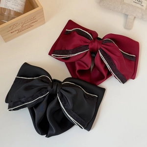 Elegant satin bow hair claws in black and burgundy with rhinestone lace edges