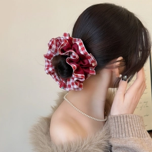 Elegant red plaid oversized scrunchie for women, styling a festive high bun hairstyle