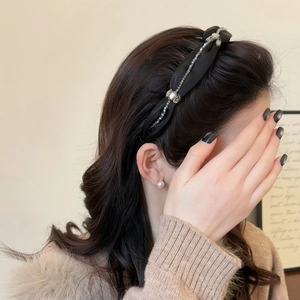 Elegant black satin headband with sparkling crystal rhinestones for a high top hair look