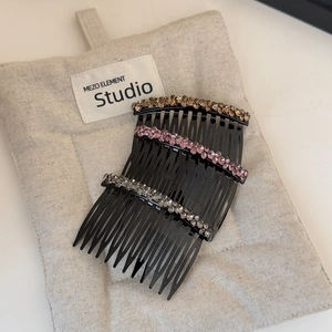 Detailed view of three-piece rhinestone hair combs in champagne, pink and clear colors