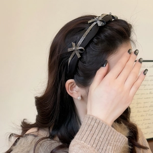 Elegant black padded headband with sparkling silver rhinestone bows for women