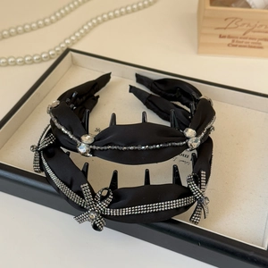 Exquisite black satin headbands with rhinestones and bow on a white vintage tray