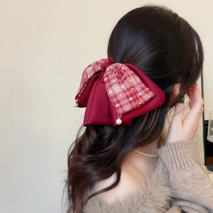 French style red checkered bow hair claw clip with pearl pendants worn by a model