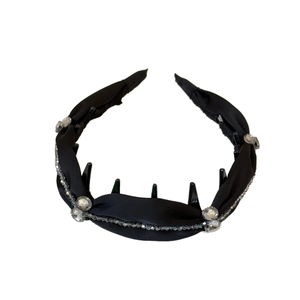 Elegant black padded headband with sparkling crystals and silver beads on white background