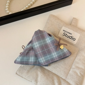 Detail of plaid fabric hair claw clip with golden Behappy pendant and bow accent