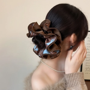 Oversized ruffled hair scrunchie with brown and blue patterns in elegant styling
