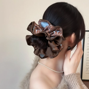 Brown floral satin scrunchie with layered folds shown on a woman ponytail hair