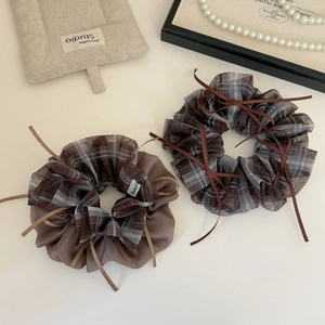 Vintage checkered mesh scrunchies with brown ribbons in a soft minimalist setting