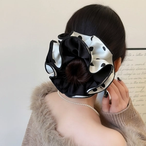 Polka dot layered hair scrunchie shown on a bun hairstyle with elegant draped ruffles