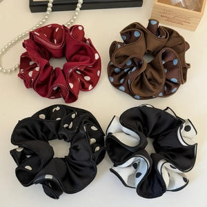 Set of four polka dot satin scrunchies in burgundy, brown, and black for elegant styling