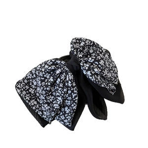 Elegant black floral bow hair claw clip with white petite flowers for women