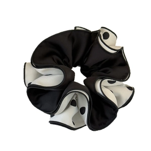 Elegant four-layer black and white polka dot scrunchie with detailed stitching