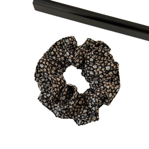 Black floral scrunchie with cream yellow flower patterns for versatile hair styling