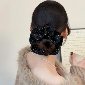 Elegant black and white polka dot oversized scrunchie for stylish bun hair styling