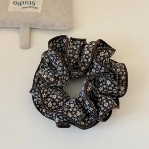 Détail du chouchou à imprimé fleuri avec coutures soignées et texture de tissu doux
