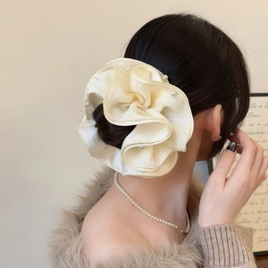 Elegant cream mesh scrunchie with white pearl trim shown on a model's ponytail hair