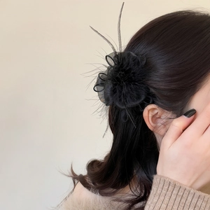 French style black feather and mesh flower hair claw clip worn by a female model