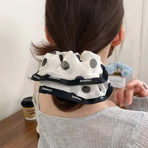Elegant polka dot chiffon hair scrunchie with lettered ribbon edge for ponytails