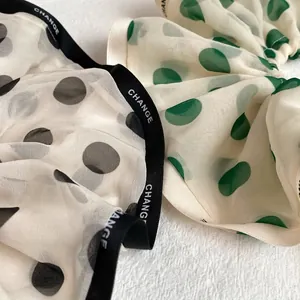 Elegant polka dot chiffon scrunchie for women featuring branded Change ribbon detail