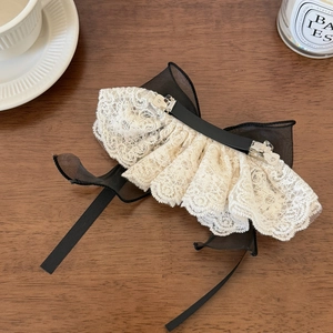 Detail of layered black organza and cream lace bow hair clip with spring metal fastener