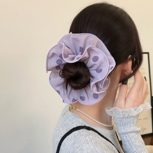 Elegant purple polka dot hair scrunchie shown on hair for a French vintage style look