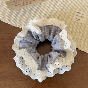 Detailed view of elegant purple checkered scrunchie with triple-layer white floral lace trim