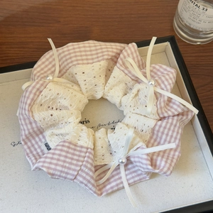 Detail of pink plaid scrunchie with delicate lace edges and white pearl satin bows