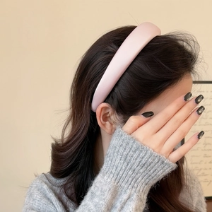 Detail of soft pink satin headband on model with high crown sponge design for women