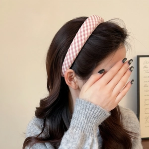 Pink and white gingham padded headband for women styled on a model in a casual setting