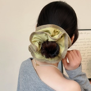Detailed view of large double-layer scrunchie in green satin and gold tweed material
