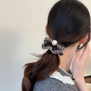 Elegant checkered plaid scrunchie with lace ruffle and large pearl worn on a ponytail